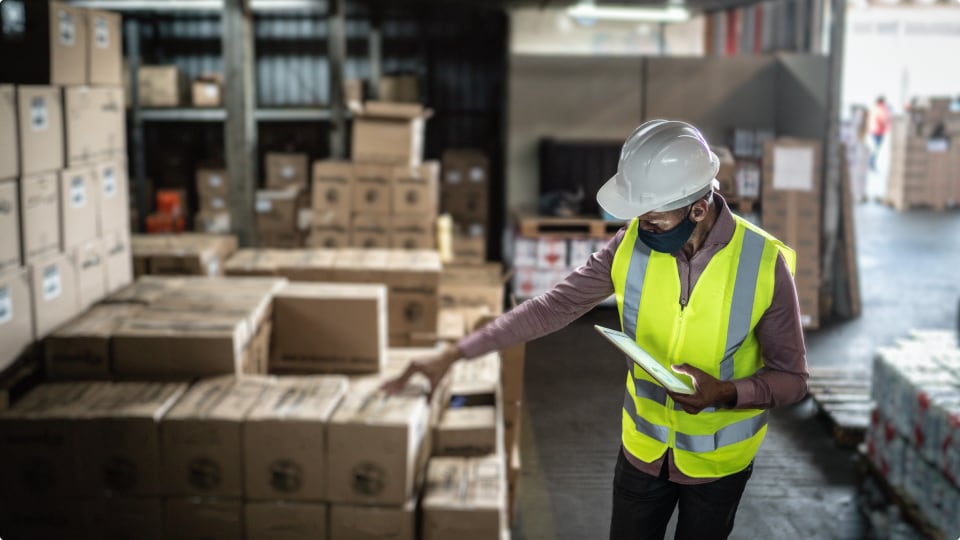 worker reviewing packages before delivery