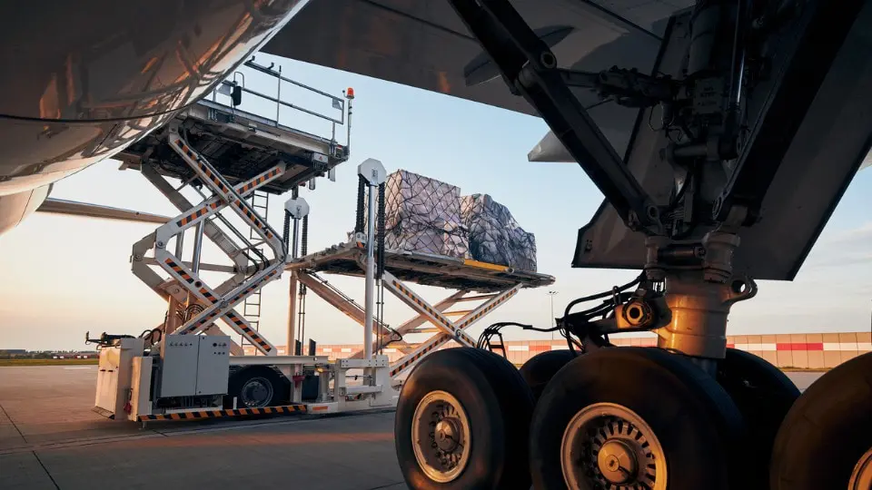 Loading of cargo containers to plane at airport