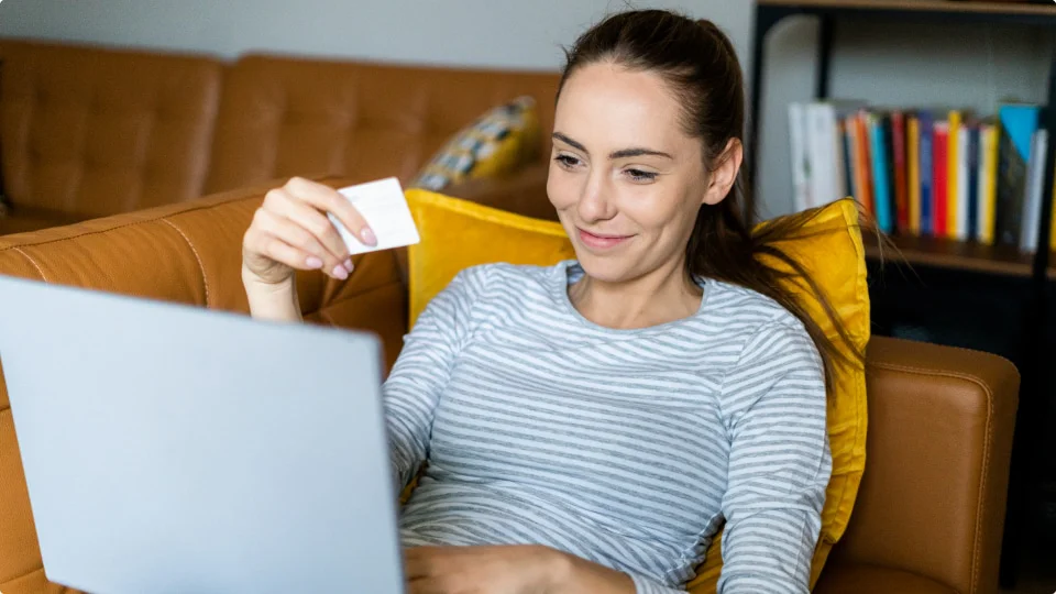 Happy woman shopping on couch