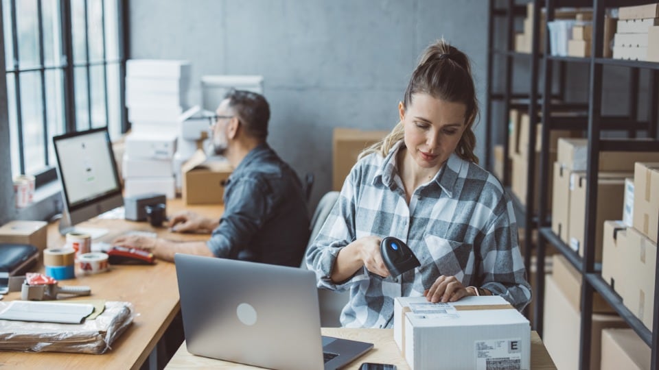 Two business partners working together at a warehouse fulfilling online orders