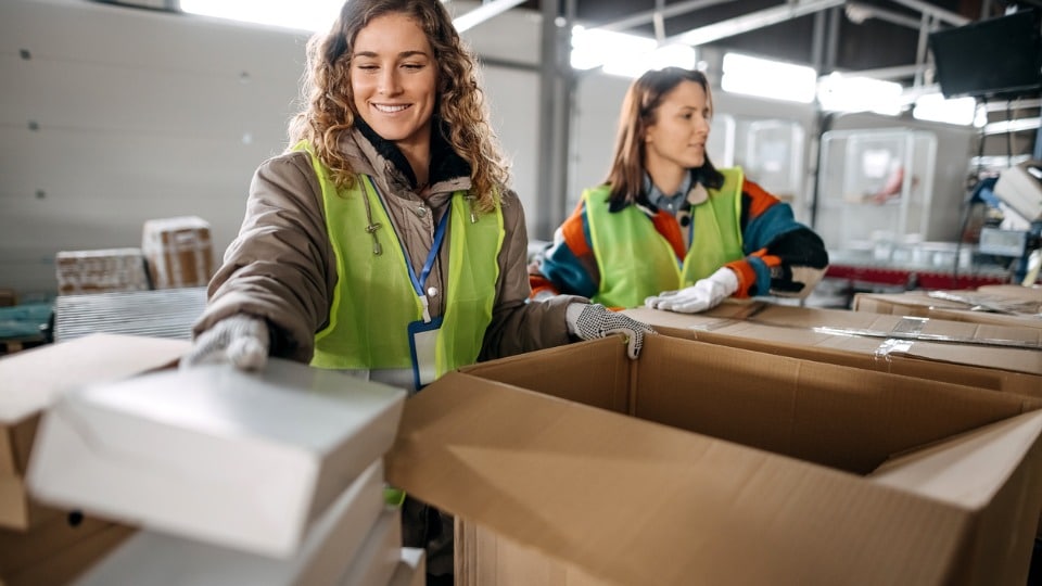 Smiling colleagues work together in a warehouse