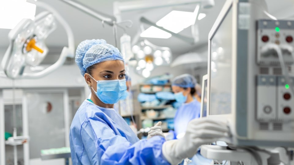 medical profession reviewing a monitor in the surgery operating room